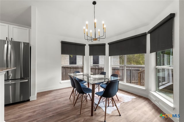 dining area with a chandelier and light hardwood / wood-style flooring