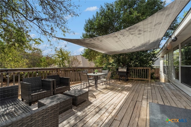 wooden deck featuring a grill