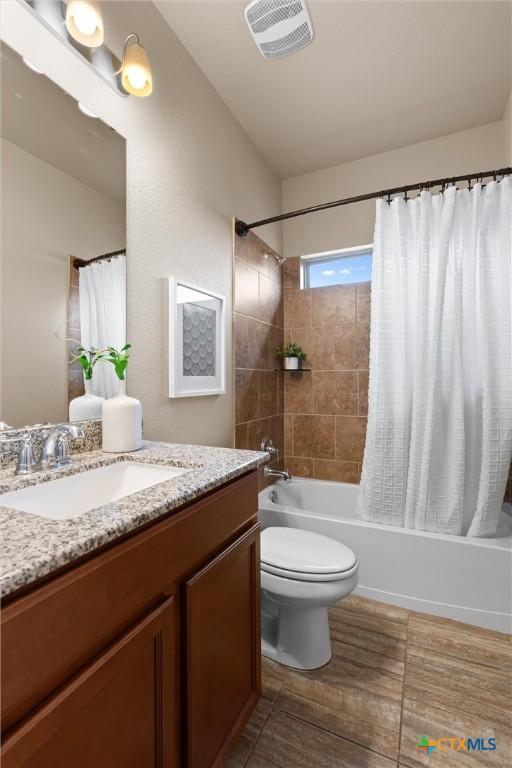 2226 Hayes St, Temple, TX 76502 - bathroom featuring vanity, shower / tub combo with curtain, and wood finished floors