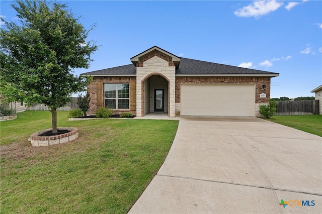 2226 Hayes St, Temple, TX 76502 - french provincial home with a garage, concrete driveway, stone siding, brick siding, and a shingled roof