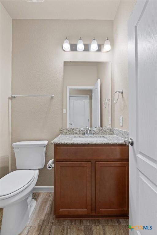 2226 Hayes St, Temple, TX 76502 - half bathroom featuring wood finished floors and vanity
