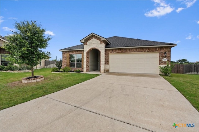 2226 Hayes St, Temple, TX 76502 - view of front of home featuring a garage, concrete driveway, stone siding, brick siding, and roof with shingles
