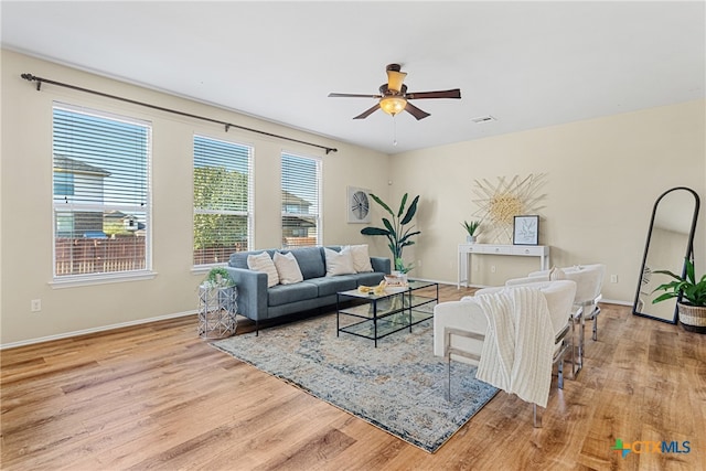 living room featuring ceiling fan and light hardwood / wood-style floors