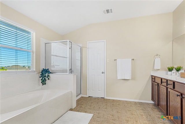 bathroom with tile patterned floors, vanity, lofted ceiling, and plus walk in shower