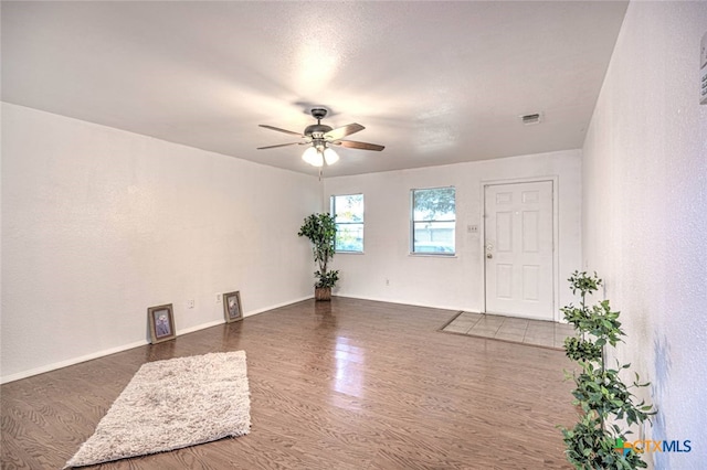 unfurnished room featuring dark hardwood / wood-style flooring and ceiling fan