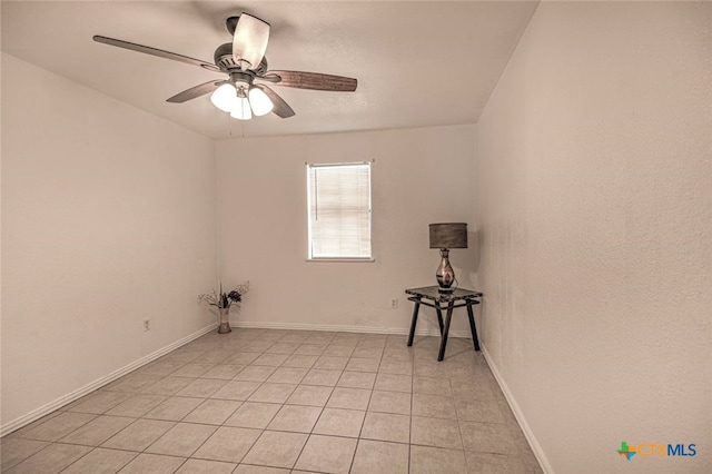 tiled spare room featuring ceiling fan