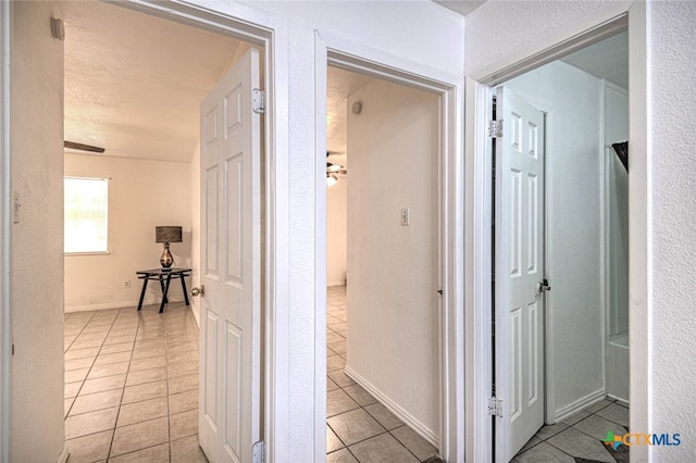 corridor with light tile patterned floors