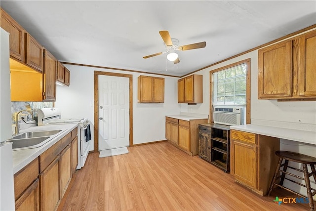 kitchen featuring white range oven, a sink, a ceiling fan, and brown cabinets