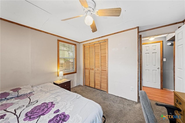 carpeted bedroom featuring a ceiling fan and a closet