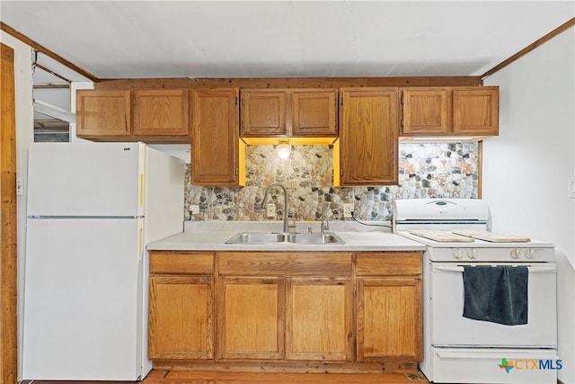 kitchen with a sink, white appliances, light countertops, brown cabinetry, and tasteful backsplash