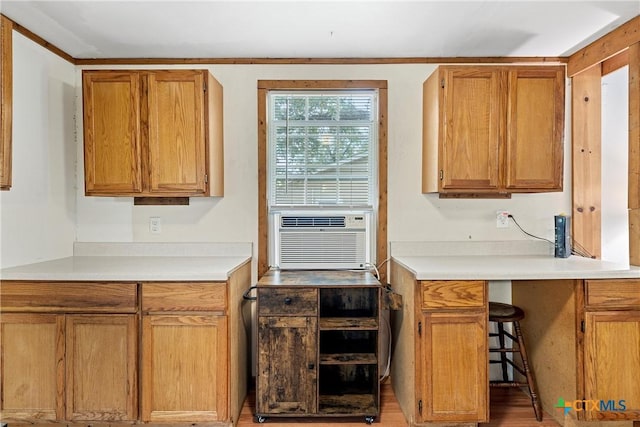 kitchen with light countertops, brown cabinets, and cooling unit