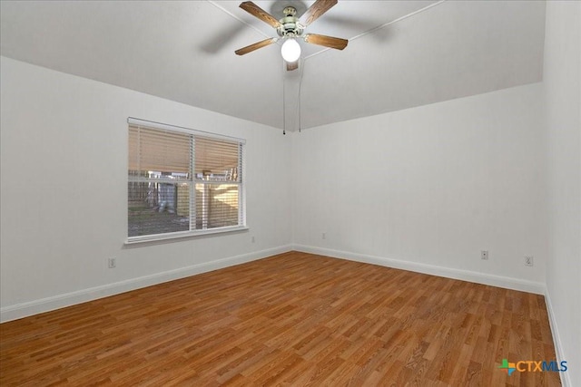 spare room with a ceiling fan, baseboards, and light wood-type flooring