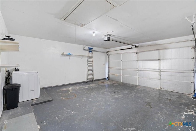 garage with washer / dryer and a garage door opener