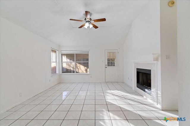 unfurnished living room featuring light tile patterned floors, lofted ceiling, ceiling fan, and a fireplace