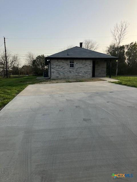 exterior space with a lawn and driveway