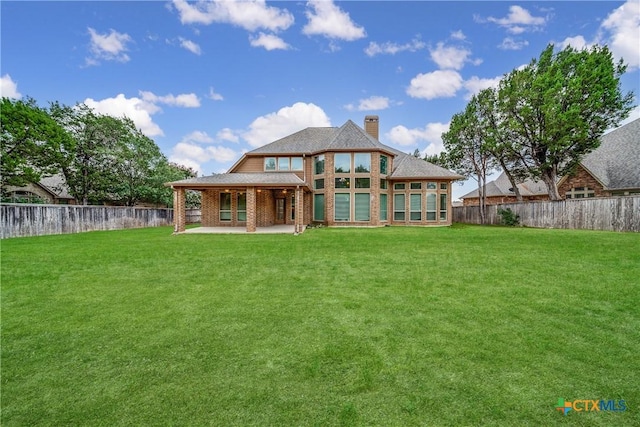 934 Wilderness Trl, New Braunfels, TX 78132 - back of property with a chimney, a patio area, and brick siding