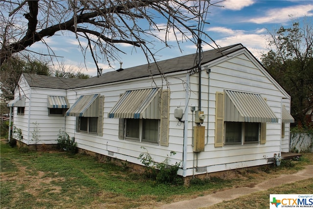 view of property exterior with a lawn