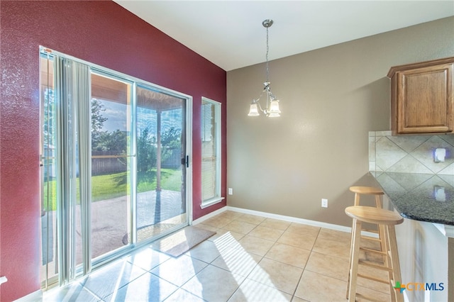 612 Weeping Willow Dr, Temple, TX 76502 - unfurnished dining area with a chandelier and light tile patterned floors