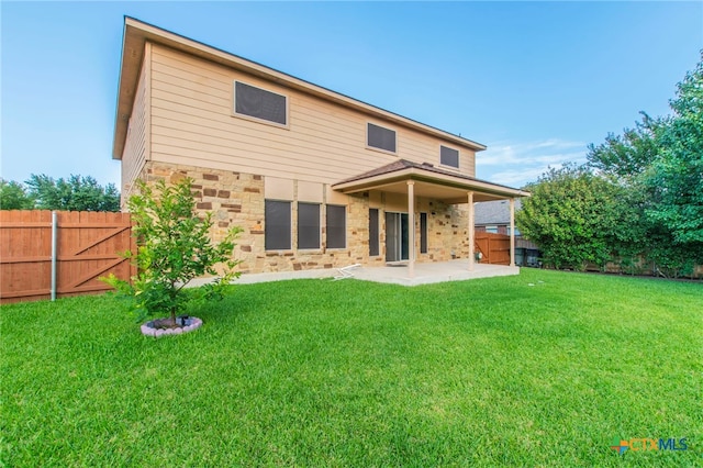 612 Weeping Willow Dr, Temple, TX 76502 - back of property with stone siding, a patio area, and a fenced backyard