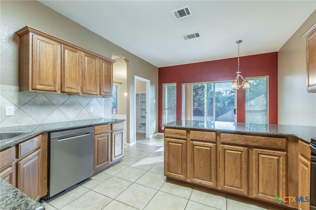 612 Weeping Willow Dr, Temple, TX 76502 - kitchen with stainless steel dishwasher, brown cabinetry, arched walkways, and decorative light fixtures