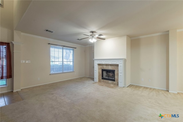 612 Weeping Willow Dr, Temple, TX 76502 - unfurnished living room featuring crown molding, ceiling fan, light colored carpet, and a tile fireplace