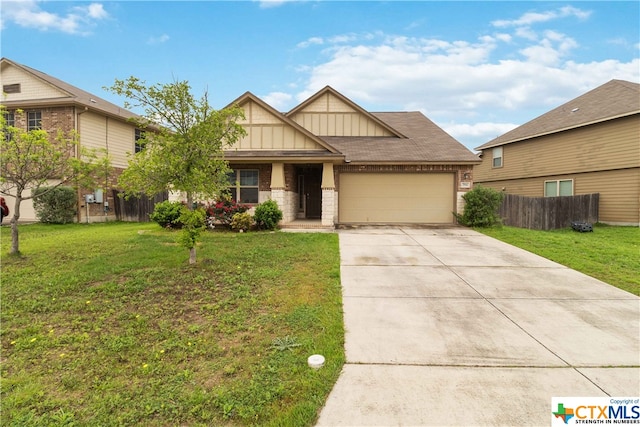 view of front of property with a front yard and a garage