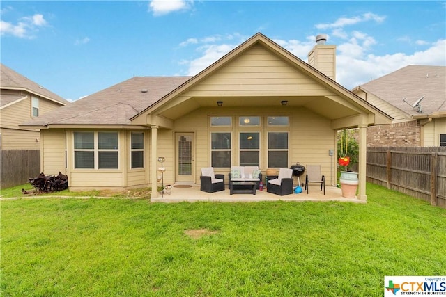 rear view of property featuring a patio area, a chimney, and an outdoor living space