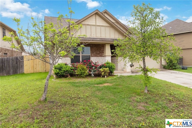 view of front of house featuring a garage and a front lawn