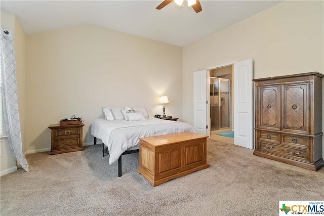 bedroom featuring light colored carpet, vaulted ceiling, ceiling fan, and connected bathroom