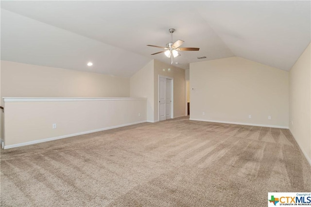 bonus room featuring vaulted ceiling, ceiling fan, light carpet, and baseboards