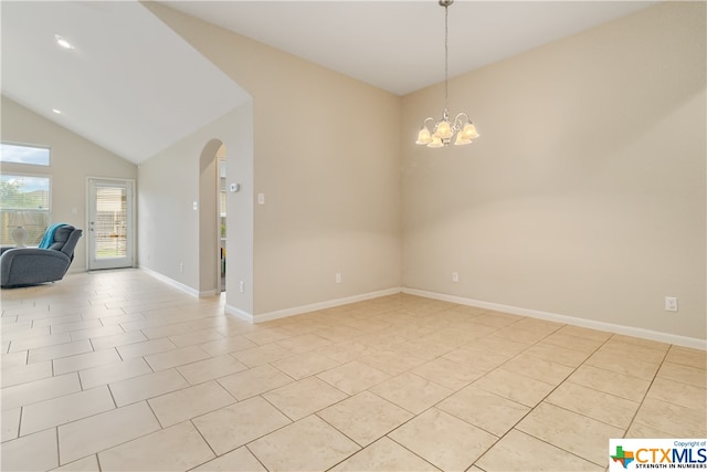 tiled spare room with a notable chandelier and vaulted ceiling