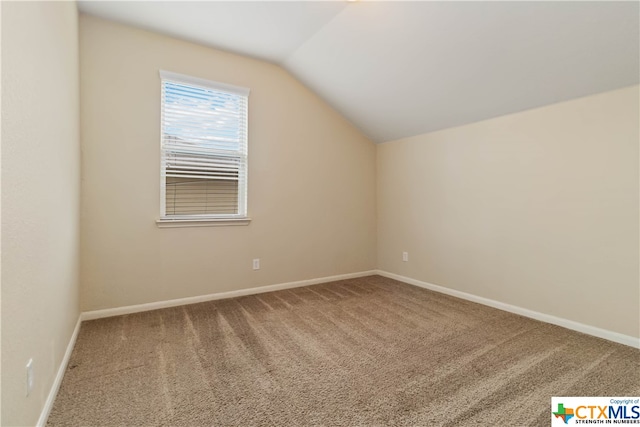 additional living space featuring carpet floors and vaulted ceiling