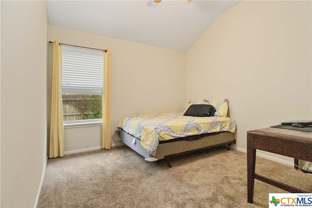 bedroom featuring light carpet and vaulted ceiling