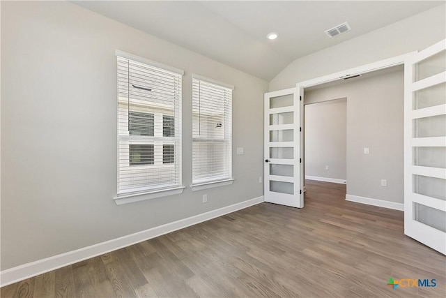 264 Sweeping Sage Ln, San Marcos, TX 78666 - empty room featuring french doors, lofted ceiling, wood finished floors, and baseboards