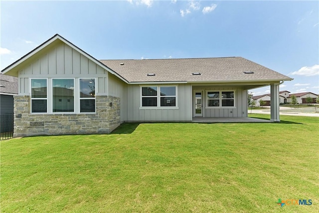 264 Sweeping Sage Ln, San Marcos, TX 78666 - rear view of house with board and batten siding and a yard
