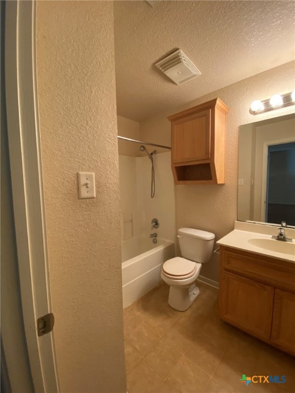 full bathroom with toilet, shower / tub combination, vanity, and a textured ceiling