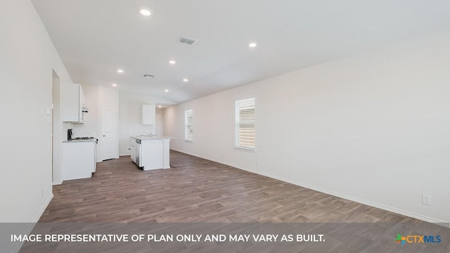 415 Gallaher Bnd, Maxwell, TX 78656 - kitchen featuring white cabinetry, wood finished floors, open floor plan, recessed lighting, and light countertops