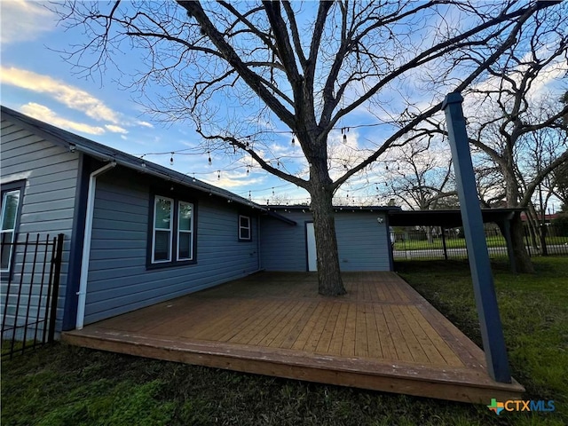 deck featuring a lawn and fence