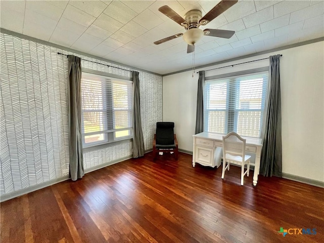 unfurnished room featuring a ceiling fan, a wealth of natural light, baseboards, and wood finished floors