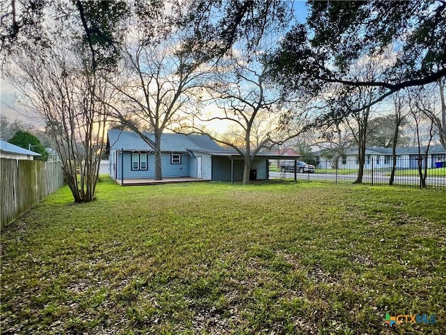 view of yard with a fenced backyard and a deck