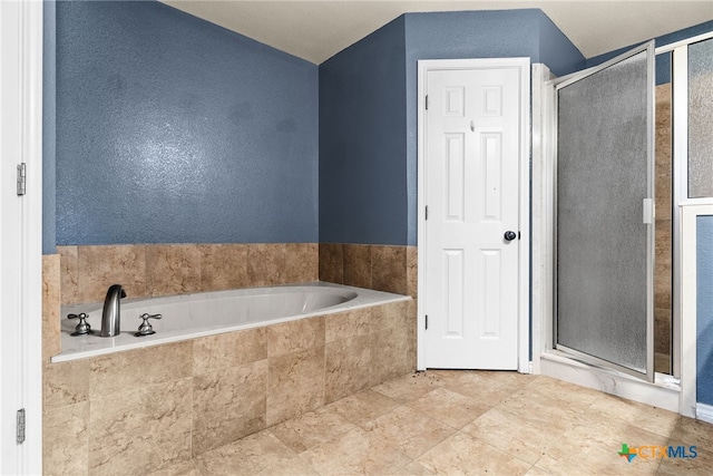 full bathroom featuring a garden tub and a stall shower