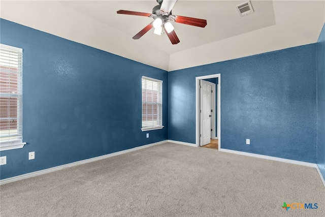spare room with baseboards, visible vents, carpet floors, and ceiling fan