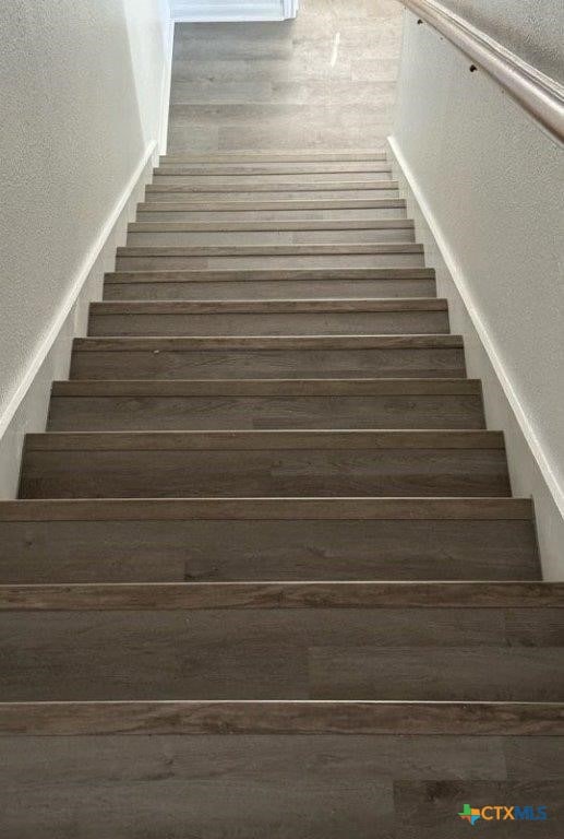 stairway featuring hardwood / wood-style flooring