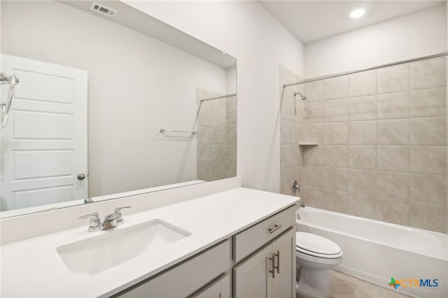 full bathroom with vanity, toilet, and tiled shower / bath