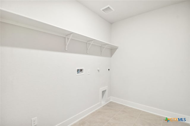 laundry area with washer hookup, electric dryer hookup, gas dryer hookup, and light tile patterned floors