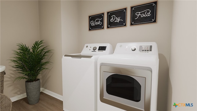 laundry area featuring hardwood / wood-style floors and washer and clothes dryer