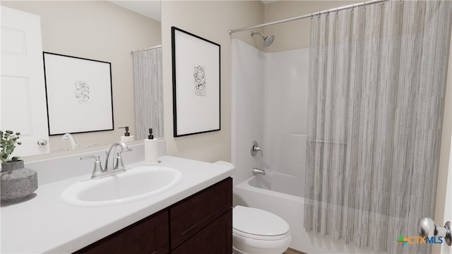 full bathroom featuring vanity, shower / bath combo with shower curtain, and toilet