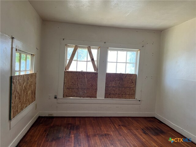 unfurnished room with dark hardwood / wood-style floors