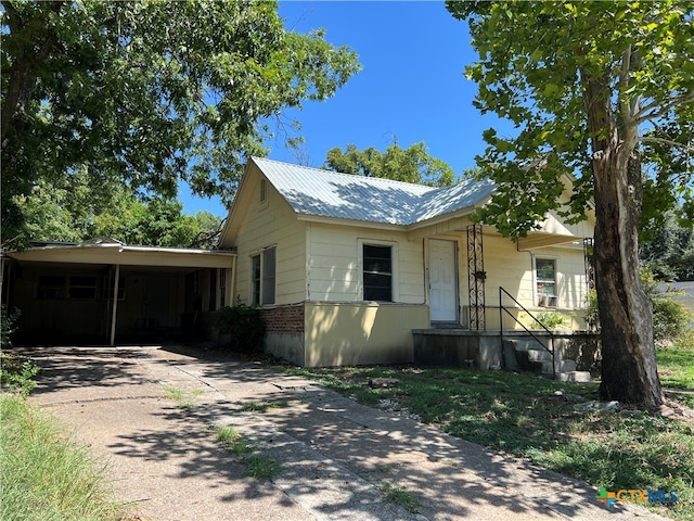 bungalow-style house featuring a carport