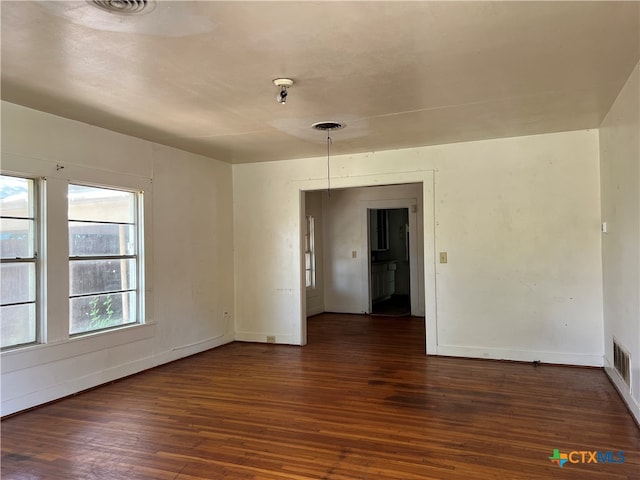 empty room featuring dark hardwood / wood-style flooring